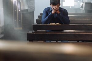 prayer sitting on bench in church