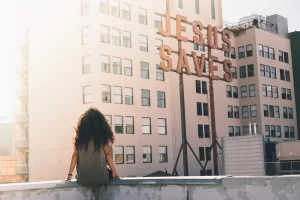 Woman gray top sitting building's