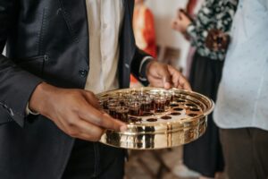 person distributing wine during mass