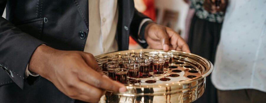 person distributing wine during mass