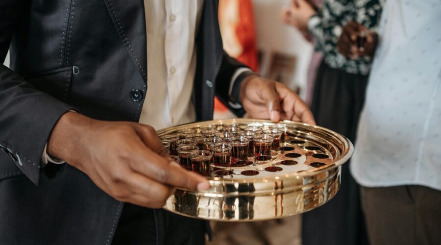 person distributing wine during mass